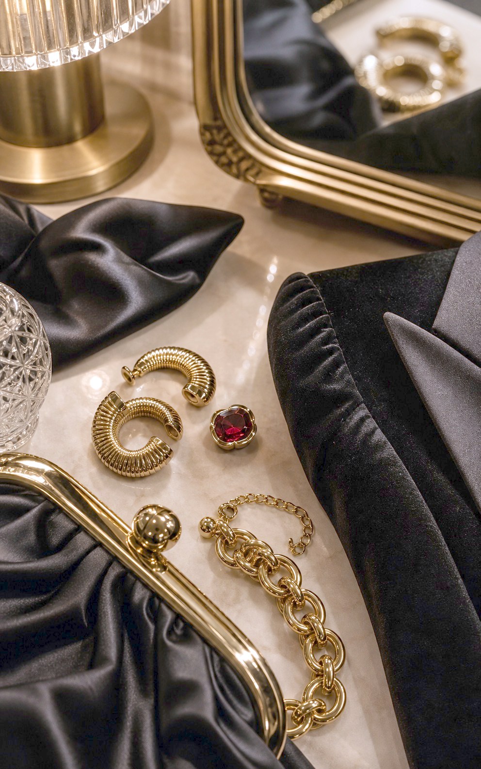 Bold gold accessories with satin black glamour details