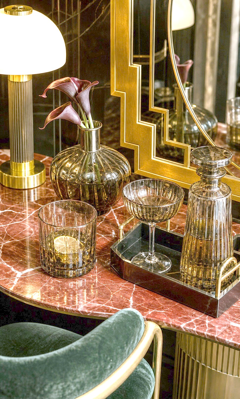 Art deco dining corner with brass and green chairs